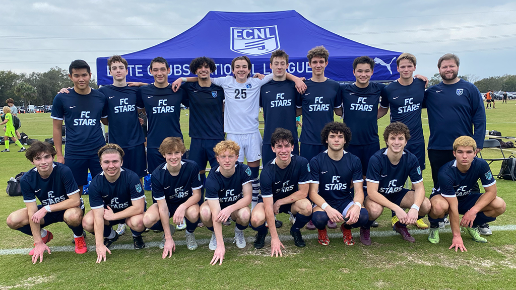 a group of boys football team posing for a photo