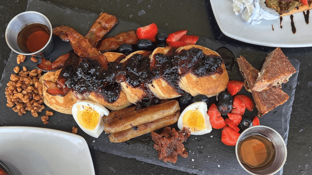 a plate of breakfast foods with a sauce on it