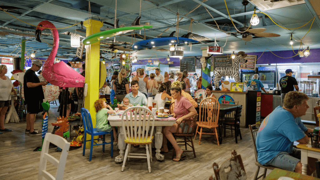 a group of people at a table in a wildly decorated cafe