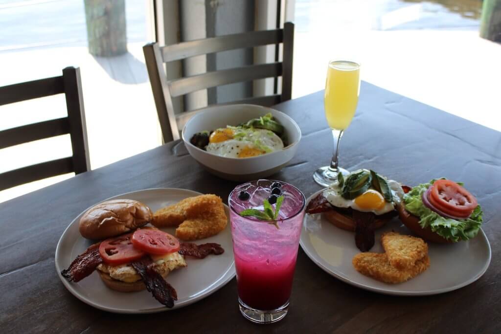 a table with plates of food and a drink