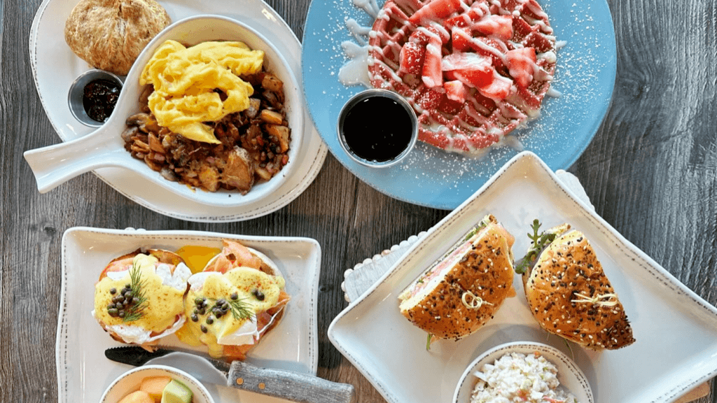 a table with plates of breakfast food