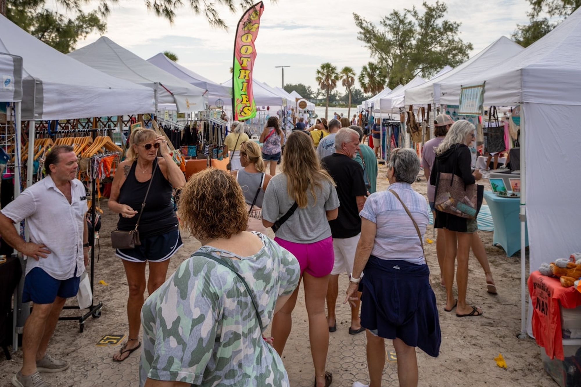 people attending coquina beach market