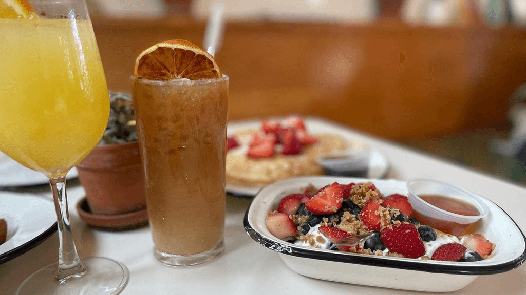 a plate of fruit and a drink on a table