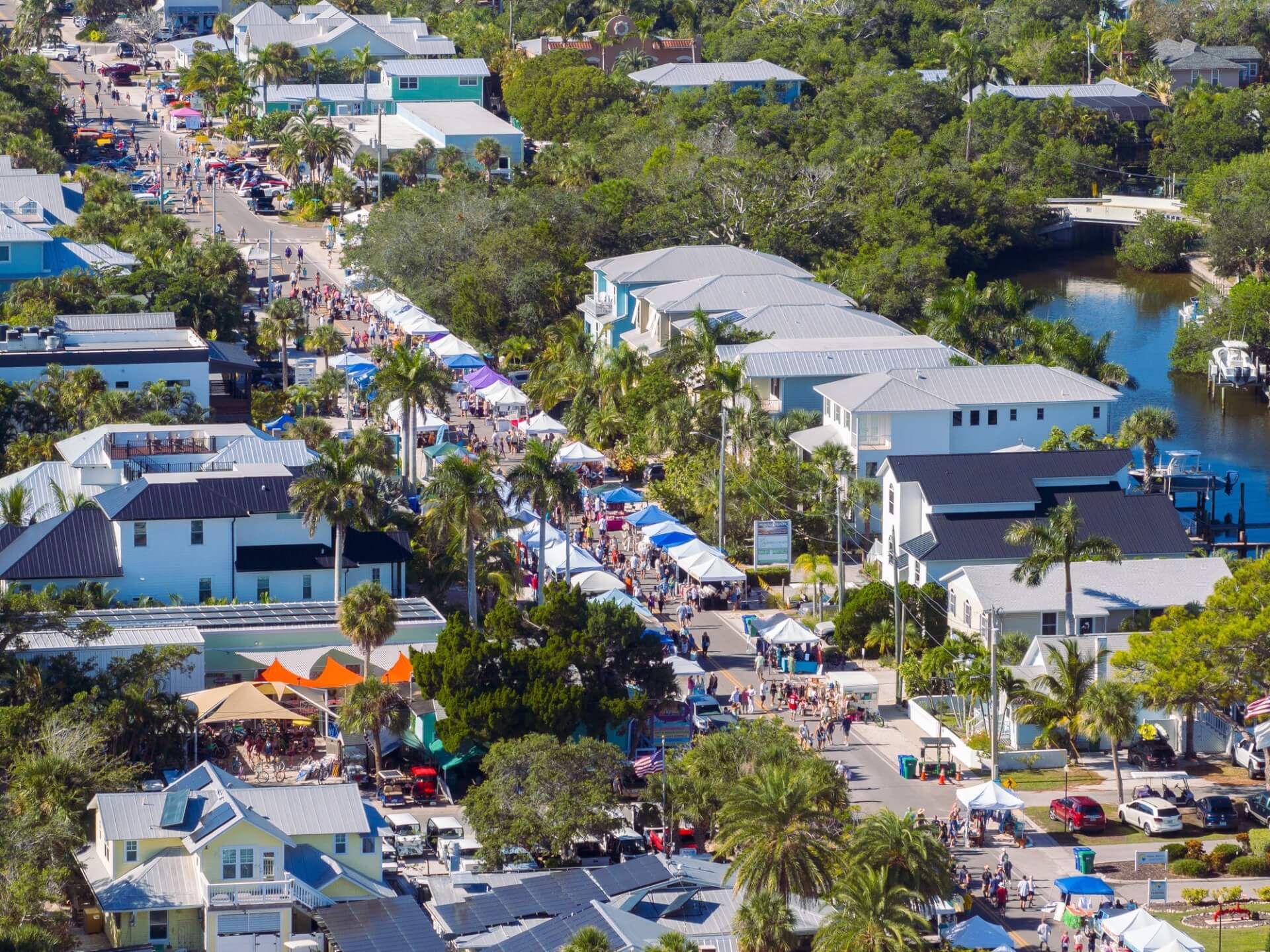 a aerial view of a street with tents and trees