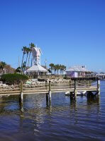 a dock with a clock tower and buildings on it