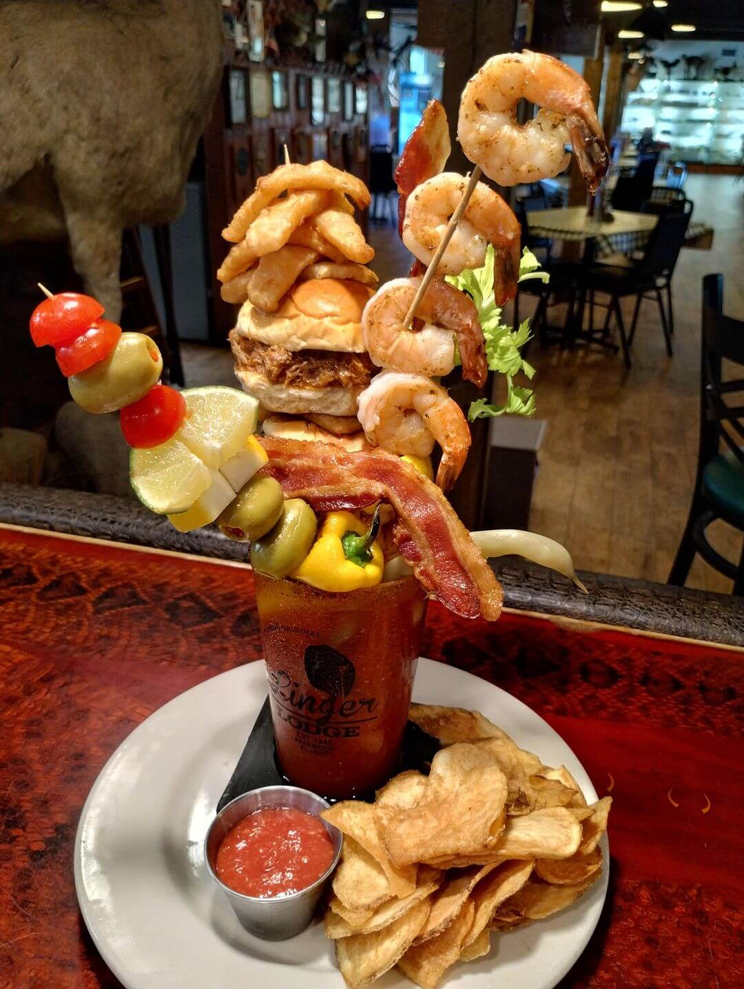 a bloody mary with shrimp and vegetables on it