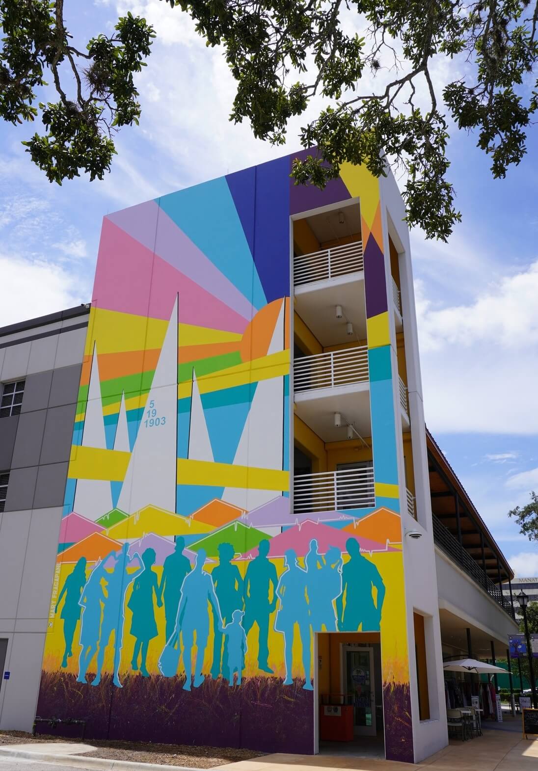 a multi-story building with a mural on the side