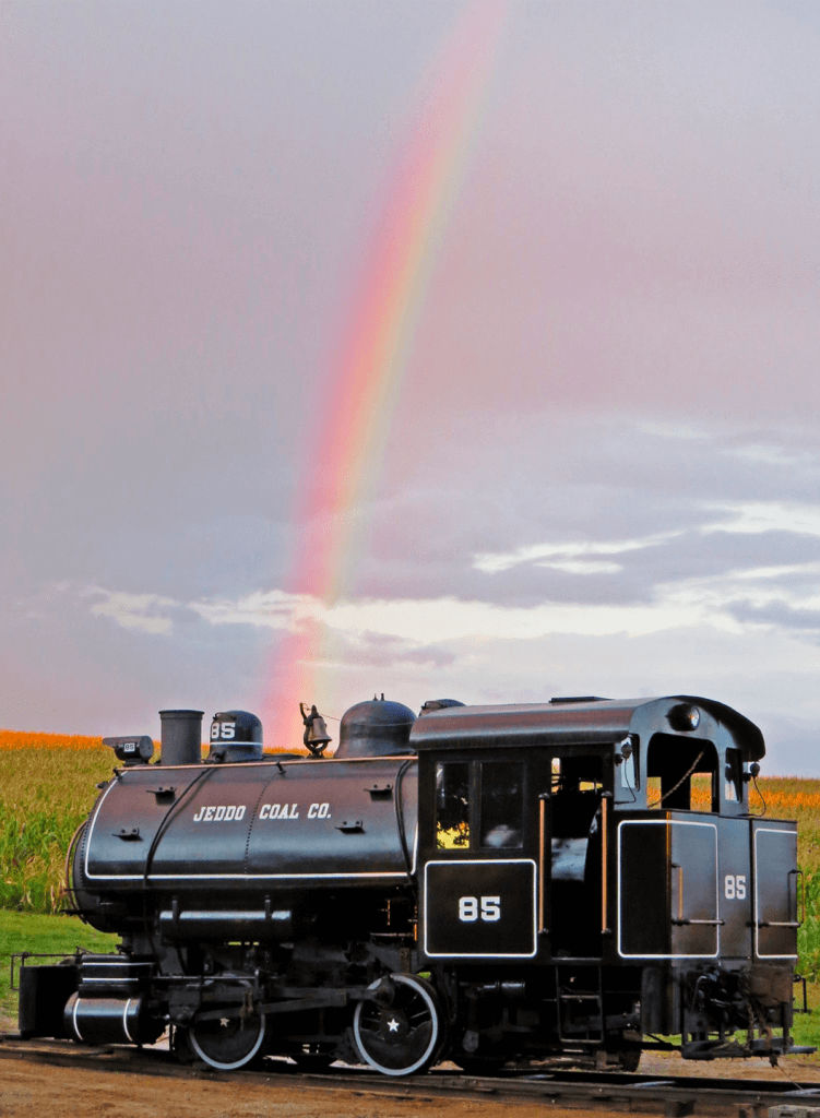 museum train with rainbow in the background
